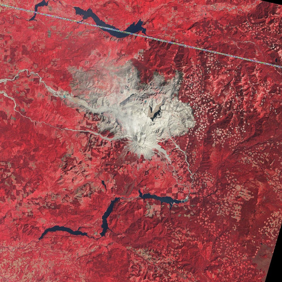 Auf roten Untergrund sind in grau-braun der Mount St. Helens und die öde Landschaft nach dem Vulkanausbruch zu sehen.